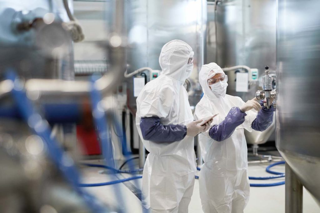 Two Workers Controlling Pharmaceutical Production